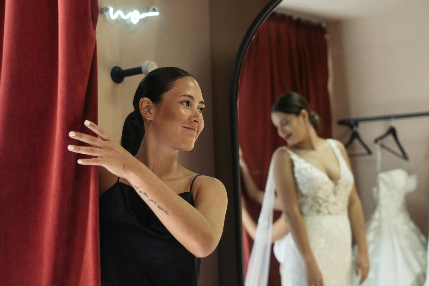 A bride trying on wedding dresses with assistance